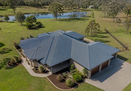 aerial view of an Australian acreage home with a grey corrugated Colorbond roof among gum trees